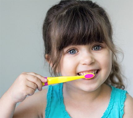  A little girl brushing her teeth 