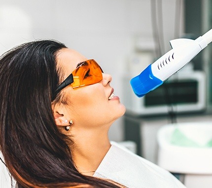 Woman receiving in-office teeth whitening treatment