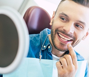 Man admiring his new dental implants in Hillsboro