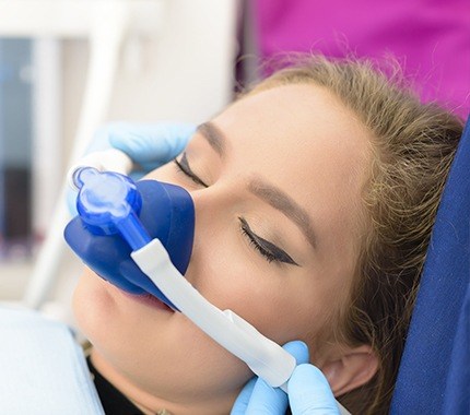 Woman with nitrous oxide sedation nose mask at dentist