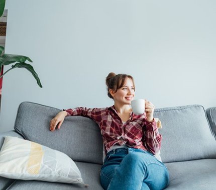 Woman relaxing on sofa at home