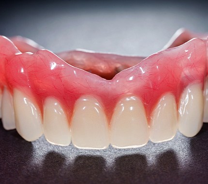 Full denture sitting on grey surface