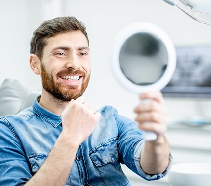 man pointing to smile after dental bonding in Hillsboro 