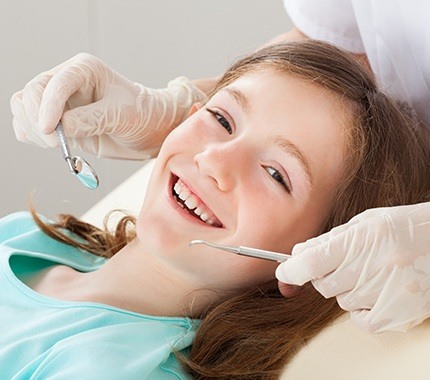 Young girl receiving dental exam