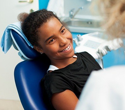 Smiling girl in dental chair