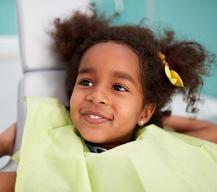Smiling young girl in dental chair