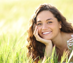 woman smiling after paying cost of cosmetic dentistry in Hillsboro