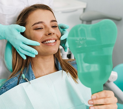 Woman preventing dental emergencies in Hillsboro by visiting the dentist