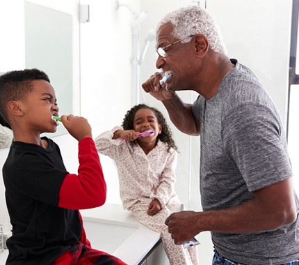 Family brushing their teeth after visiting dentist in Hillsboro