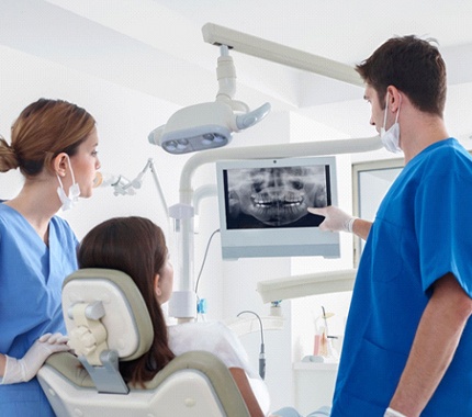 dentist showing a patient their X-rays