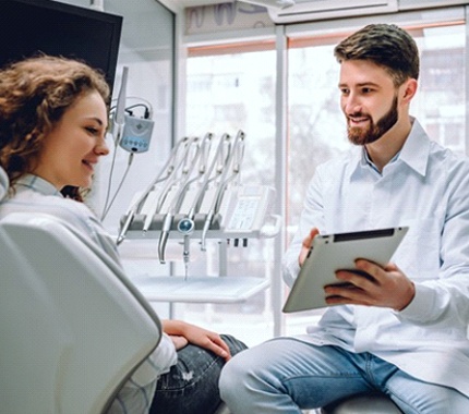 dentist showing a patient a tablet