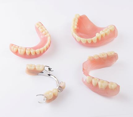 Close up of a set of immediate dentures being held out