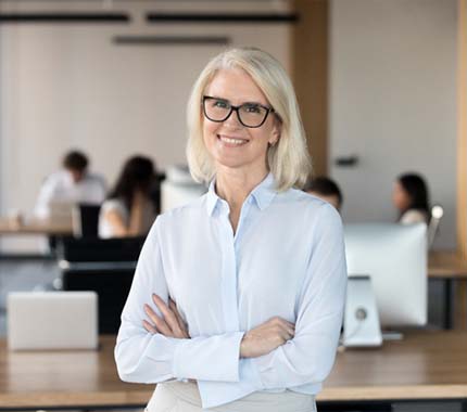 Portrait of confident, mature businesswoman with implant dentures