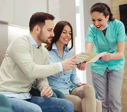 Two dental patients looking at dental insurance forms