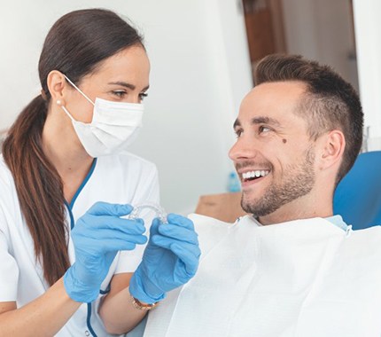 dentist showing Invisalign to a patient 