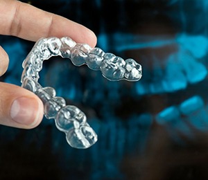 person holding Invisalign aligner 