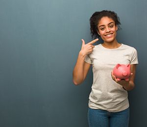 woman with piggy bank pointing to her smile 