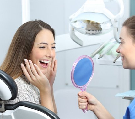 Woman admiring her smile after a smile makeover in Hillsboro