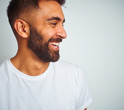 man smiling after getting metal free restorations in Hillsboro