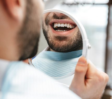 man smiling with metal free restorations in Hillsboro