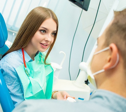 A woman speaking with a dentist.