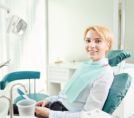 Female dental patient smiling after scaling and root planing in Hillsboro, OR