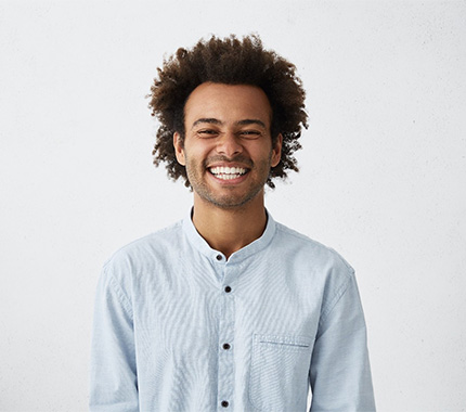 man smiling after getting root canal therapy in Hillsboro