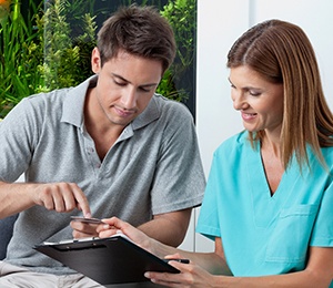 A man paying the cost of a root canal in Hillsboro