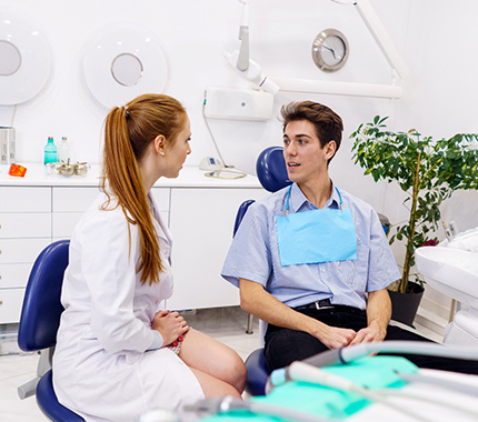 A dentist answering a patient’s questions