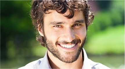 Young man with healthy smile outdoors