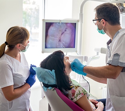 Patient and dentist looking at intraoral images