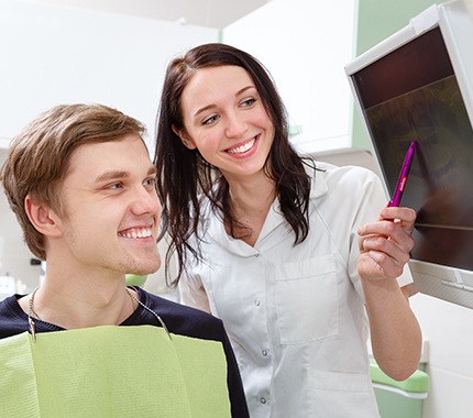 Dentist and patient looking at dental x-rays