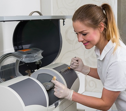 Dental team member using CEREC system