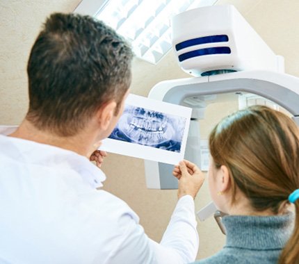 Dentist showing woman her dental X-ray