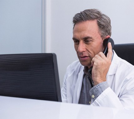 Dentist in Hillsboro talking to patient on the phone