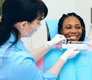 Dentist holding shade guide 