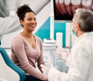 Cosmetic dentist talking to patient about teeth whitening