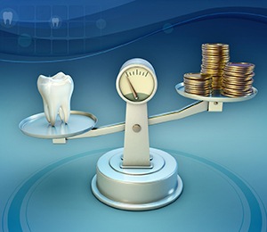 Tooth and coins on balance scale