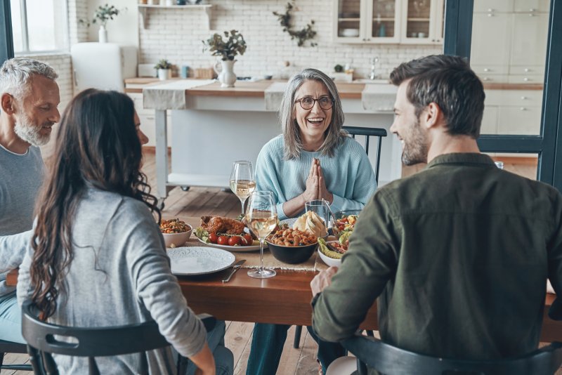 family smiling during Thanksgiving dinner