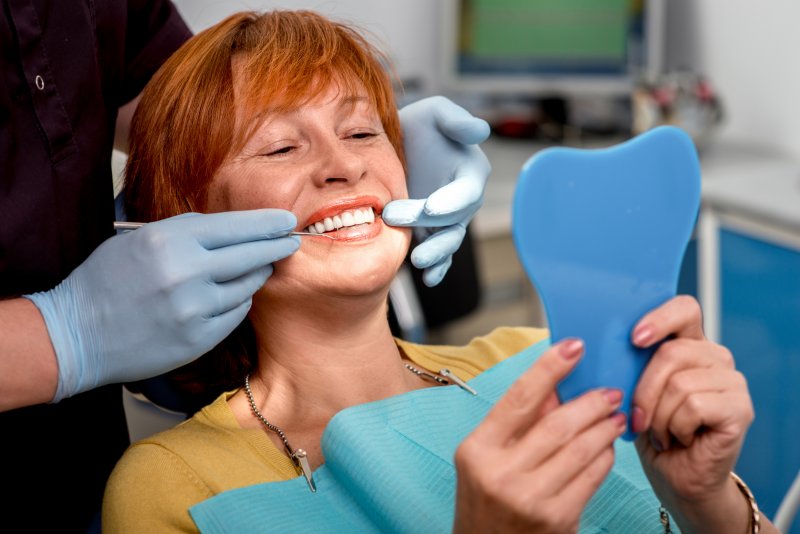 woman smiling after getting dental implants